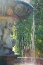 Baroque girl statue with fountain water falling down Royalty Free Stock Photo