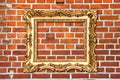 Baroque golden frame on red brick wall Royalty Free Stock Photo