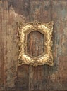 Baroque golden frame on wooden background. Grunge texture Royalty Free Stock Photo