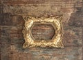 Baroque golden frame on wooden background. Grunge texture Royalty Free Stock Photo