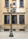 Baroque lamp in Galatina with coat of arms on background windows