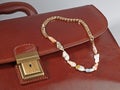 Baroque pearl golden chain necklace on male brown leather case