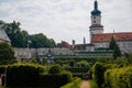 Baroque romantic castle Nove mesto nad Metuji with park, renaissance chateau, round white clock tower, red tile roof, Italian