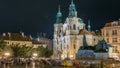 Baroque St. Nicholas' Cathedral on the Oldtown Square in Prague with monument Jan Hus illuminated at night timelapse Royalty Free Stock Photo