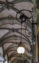 Baroque covered arcade and ornate art nouveau light fixture in Porto, Portugal