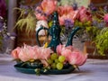 Baroque style flower arrangement with oriental dark green tea pot on the table. Royalty Free Stock Photo