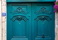 Baroque style sculptural details of gorgeous antique wooden door painted in beautiful aquatic blue color. Top part of doorway Royalty Free Stock Photo