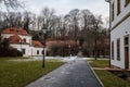 Baroque white benedictine monastery Brevnov with church, Pavilion Vojteska, Garden and park, abbey under snow in winter day, Royalty Free Stock Photo