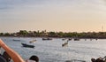 BARRA, GAMBIA, AFRICA - CIRCA MARCH, 2017: Ferry navigates through fisher boats on it's way to the harbor