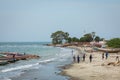 BARRA, THE GAMBIA - NOVEMBER 18, 2019: Pleople workingh at the beach in Barra, Gambia Royalty Free Stock Photo