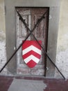 Barred door with medieval crossed spears and shield . Entry blocked . Access denied