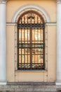 Barred old window between two white columns Royalty Free Stock Photo