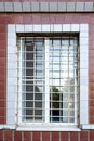 Barred window close-up. White grille on the window