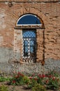 Barred window in an old brick building. Royalty Free Stock Photo