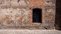 Barred window in an old red brick wall Royalty Free Stock Photo