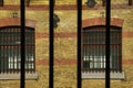 Barred windows seen through a prison cell window with metal bars Royalty Free Stock Photo