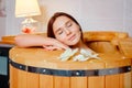 Barrel cedar. Wellness spa sauna. Aromatherapy treatment. Young beauty woman. Girl face Royalty Free Stock Photo