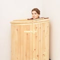 Barrel cedar. Wellness spa sauna. Aromatherapy treatment. Young beauty woman. Girl face