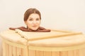 Barrel cedar. Wellness spa sauna. Aromatherapy treatment. Young beauty woman. Girl face Royalty Free Stock Photo