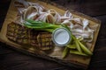 Barrel cucumbers, sliced lard, fried bread and onions on the wooden board on gray background. Flat lay composition Royalty Free Stock Photo