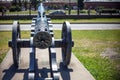 Barrel of old vintage cast iron cannon on wheels and carriages with a blurred background