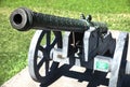 Barrel of old vintage copper cannon on wheels and carriages with a blurred background