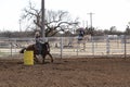 Wman competing in a barrel race in small town in West Texas