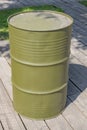 Khaki aluminum oil barrel stands on the street