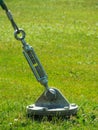 A barrel strainer anchored in grass.