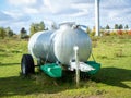 Barrel with water. Mobile drinker for cows. Royalty Free Stock Photo