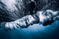 Barrel wave underwater with air bubbles. Royalty Free Stock Photo