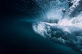 Barrel wave underwater with air bubbles and sun light. Royalty Free Stock Photo
