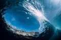 Barrel wave underwater with air bubbles and sun light. Ocean in underwater Royalty Free Stock Photo