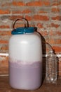 A barrel of young wine fermenting under a water seal. Homemade grape wine production