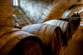 Barrels in a rustic wine cellar