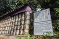 Barrels of Sake wrapped in Straw stacked on shelf with description board Royalty Free Stock Photo