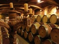 Barrels in underground wine cellar. Royalty Free Stock Photo