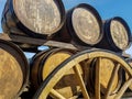 Barrels with wine on the wooden wagon wheel retro