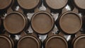 Barrels of wine, whiskey, bourbon liqueur or cognac in the basement. Aging of alcohol in oak barrels in warehouse. Wine Royalty Free Stock Photo