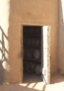 Barrels in a winery through the door of cellar