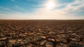 barren field stretching to the horizon, the parched earth cracked and dry under the unforgiving sun Royalty Free Stock Photo