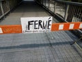 Barricade with closed danger falling bricks sign in French and metal walkway Royalty Free Stock Photo