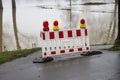 Barrier at an asphalt way due to high water on the rhine river