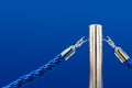 Barrier fence, velvet and metal racks. Close-up of a portable barrier with a blue rope against Royalty Free Stock Photo