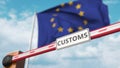 Barrier gate with CUSTOMS sign being closed with flag of the EU as a background. European Border closure or protective