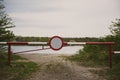 the barrier with a no entry sign . Road leads to the river Royalty Free Stock Photo