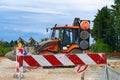 Barrier at a road construction site. The construction site is protected by warning signs Royalty Free Stock Photo