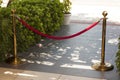 Barrier rope photo Golden stanchions with a red rope. Barrier, enclosed VIP area, protected entrance, private event, luxury gala