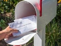 Barrington, IL/USA - 08/22/2020: Homeowner receives applications for mail-in voting in home mailbox via US Postal Service