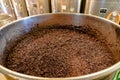 Barrique pinot noir grapes fermenting in an open tank during wine-making